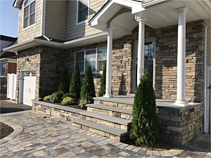 natural looking cultured stone boral chardonnay country ledgestone planter wall bluestone cap around garage and front of house steps